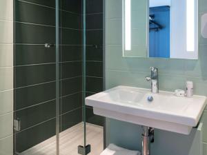 a bathroom with a sink and a shower at Ibis Styles Paris Gare Saint Lazare in Paris