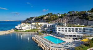 an aerial view of a hotel and the water at nhow Marseille in Marseille