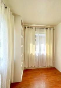 a room with white curtains and a window at Camella Home Greta Model Rental in Bacolod in Bacolod