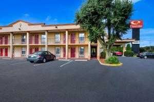 a hotel with a car parked in a parking lot at Econo Lodge in Princess Anne