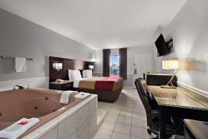 a hotel room with a bed and a bath tub at Econo Lodge Princess Anne in Princess Anne