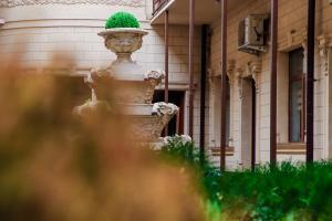 Fotih Hotel في Sergeli: تمثال مع قبعة خضراء في مقدمة المبنى