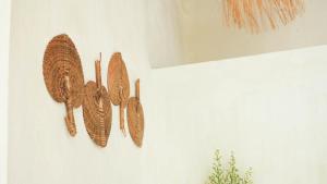 a group of feather hooks hanging on a wall at Ulunia in Uluwatu