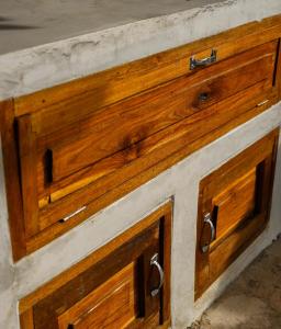 a wooden drawer with two handles on a cabinet at Ulunia in Uluwatu