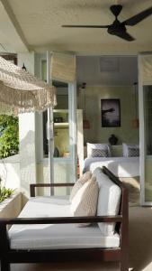 a bedroom with two beds and a ceiling fan at Ulunia in Uluwatu
