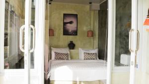 a bedroom with a bed and a glass door at Ulunia in Uluwatu