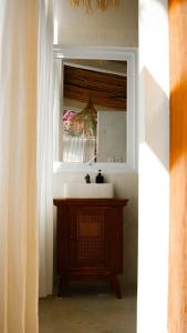 a bathroom with a sink and a mirror at Ulunia in Uluwatu