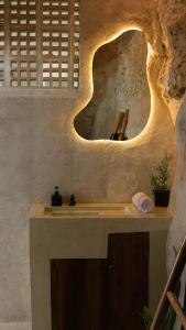 a bathroom with a sink and a mirror at Ulunia in Uluwatu