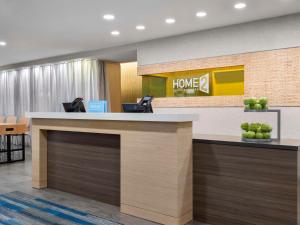 an office lobby with a home 94 sign on the wall at Home2 Suites by Hilton Orlando South Davenport in Davenport +26 photos