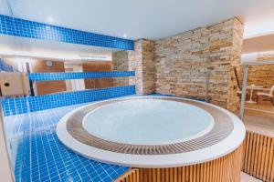 a hot tub in a bathroom with blue tiles at Hotel Spa Republica in Mar del Plata