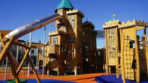 a playground with a large wooden play structure at Casa económica Madrid in Leganés