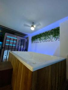 a bathroom with a white sink in a room at Hotel Hostal Caps Cartagena in Cartagena de Indias