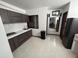 a kitchen with a sink and a refrigerator at Hotel SG in Doradal
