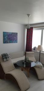 a living room with a couch and a table at City center apartment in Pieksamaki +2 photos