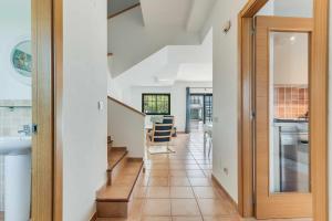 a hallway with a door leading into a kitchen with a staircase at Residencial Las Candelarias 35 in Agaete