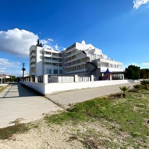 a large white building in front of a building at AFYTOS ÖREN BEACH PRESTİJ in Burhaniye