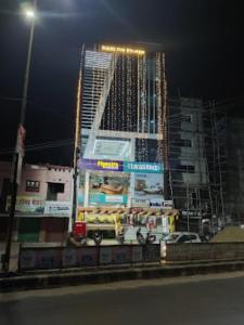 a gas station in front of a tall building at night at HOTEL Z SQUARE , Aurangabad in Aurangābād