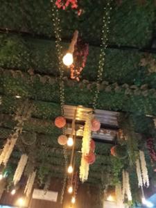 a ceiling with flowers and lights in a building at HOTEL Z SQUARE , Aurangabad in Aurangābād