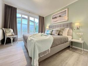 a bedroom with a bed with a table in it at Am Stadtwald in Kühlungsborn