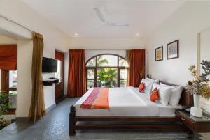 a bedroom with a large bed and a large window at Brahma Niwas - Best Lake View Hotel in Udaipur in Udaipur