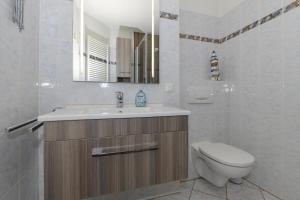 a bathroom with a sink and a toilet and a mirror at Am Stadtwald in Kühlungsborn +48 photos