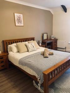 a bedroom with a large bed with pillows on it at The Cottage Inn in Llandeilo