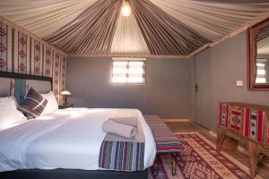 a bedroom with a large bed in a tent at Rahayeb Desert Camp in Wadi Rum