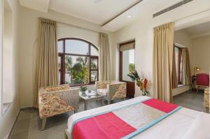 a bedroom with a bed and a table and chairs at Brahma Niwas - Best Lake View Hotel in Udaipur in Udaipur