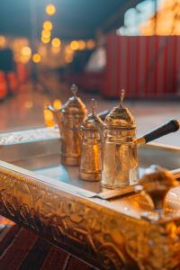 a tray with four tea pots on a table at Rahayeb Desert Camp in Wadi Rum