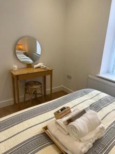 a bedroom with a bed with a mirror and a table at Brand NEW apartment with FREE Parking, Sleeps 4, near Beach & City Centre in Waterloo