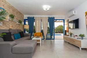 a living room with a couch and a table at Villa Valentina Private Pool Playa Blanca By PVL in Playa Blanca