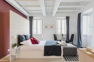 a bedroom with a large bed with red and white walls at La Casetta a Monti in Rome