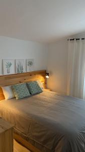 a bedroom with a large bed with a wooden headboard at Can Marasí in Lloret de Mar