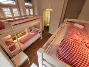 two bunk beds in a room with a hallway at Adventure Hostel Interlaken in Interlaken