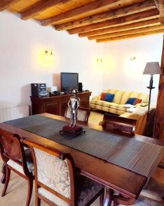 - un salon avec une table et un canapé dans l'établissement Casa Rural Casona Camino Pedraza - 4 Estrellas, à Arcones