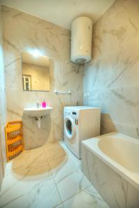 a bathroom with a washing machine and a sink at Bright & modern 2bedrooms with sea views GOGZR1-2 in Il-Gżira