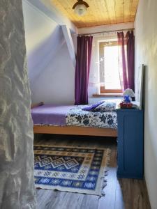 a small bedroom with a bed and a window at Siedlisko Otulenie in Bartoszyce