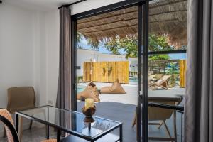 a room with a glass table and a view of a pool at Manao Seaview Pool Villa 44 - 5 Mins Walk To The Beach in Ko Lanta