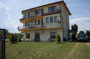 a house with a car parked in front of it at Guest House Golden Flake 4km from Bolata beach in Bŭlgarevo