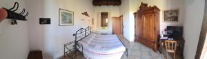 a bedroom with a bed and a dresser in a room at Azienda agricola biologica Le Lucciole in Bertinoro