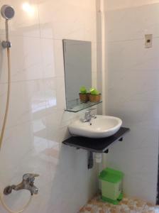 a bathroom with a sink and a mirror at Ngoc Binh Hotel in Hue