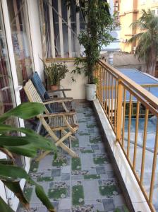 a porch with chairs and plants on a balcony at Ngoc Binh Hotel in Hue