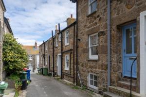 an alley in an old town with stone houses at Harbour Moorings in St Ives