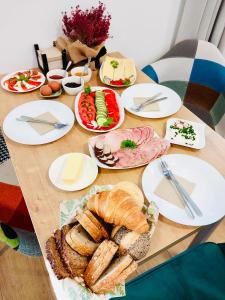 drewniany stół z talerzami żywności w obiekcie Pod Gromadzyniem Resort w mieście Ustrzyki Dolne