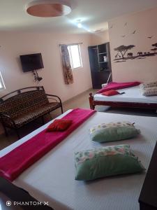 A bed or beds in a room at Sugan Residency