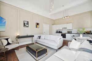 a living room with a white couch and a table at (G1) Elegant 2 bed Blythswood Apartment in Glasgow