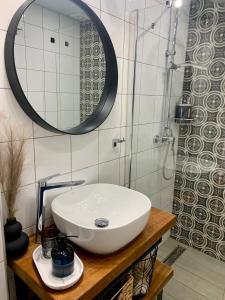 a bathroom with a white sink and a mirror at Under the Aqueduct boutique house in Kavála