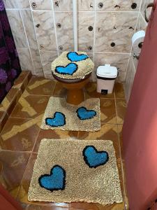 un cuarto de baño con dos alfombras con corazones azules. en Leosan departamento en Puerto Iguazú