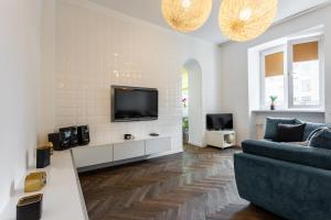 a living room with a couch and a tv at Golden Apartments Warsaw - Top Location - Krakowskie in Warsaw