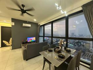 a living room with a table and a ceiling fan at New Brand KTV SET, Netflix, 3 Queen Bed High Floor in Jelutong